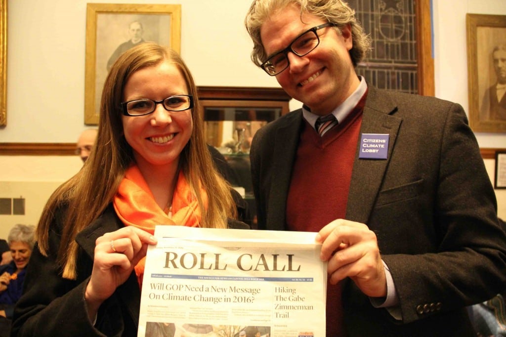 Ashley Hunt-Martorano CCL Global Strategy Director Joe Robertson hold a copy of Roll Call with the interesting story of the day. (Photo by Erica Flock)