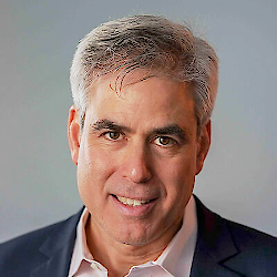 Headshot of Jonathan Haidt. Jonathan is wearing a suit, smiling, and looking at the camera.