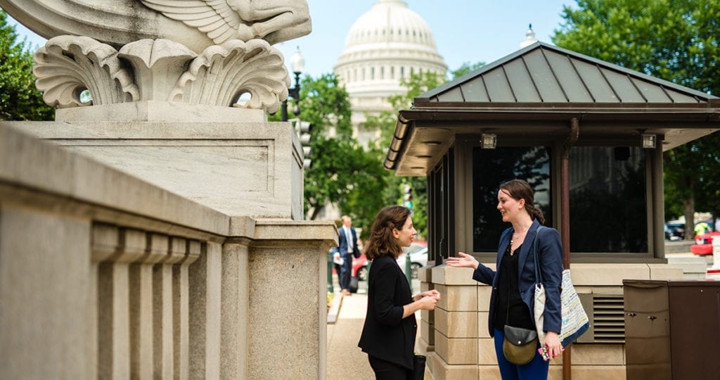 Volunteers on Capitol Hill discussing the bipartisan Climate Solutions Caucus