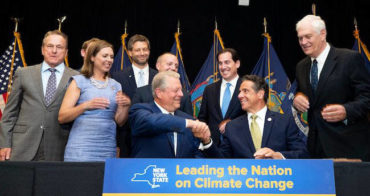 Governor Cuomo shaking hands with former Vice President Al Gore at a bill-signing ceremony