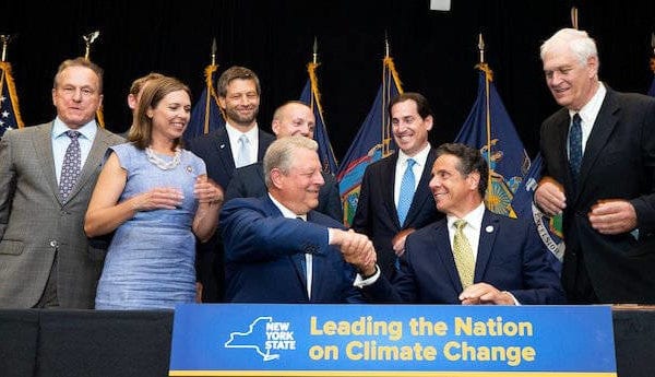 Governor Cuomo shaking hands with former Vice President Al Gore at a bill-signing ceremony