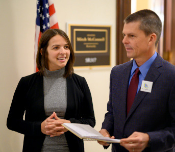 Two conservative CCL supporters, a female and a male, standing in the hallway outside of a member of Congress' office in Washington DC.