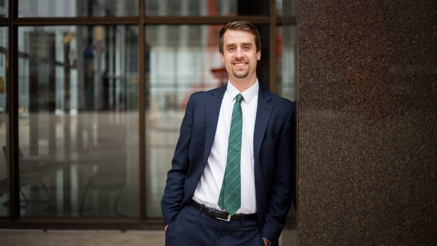 Kyle Meyaard Schaap leans against a building for a front profile photo. 