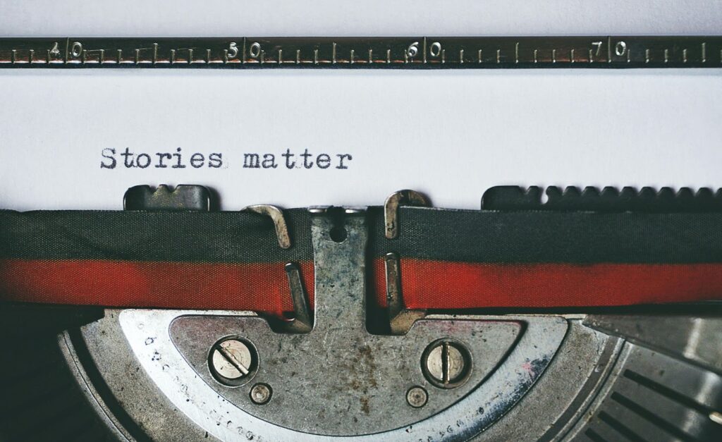 A close up image of a typewriter displays the words "Stories matter"