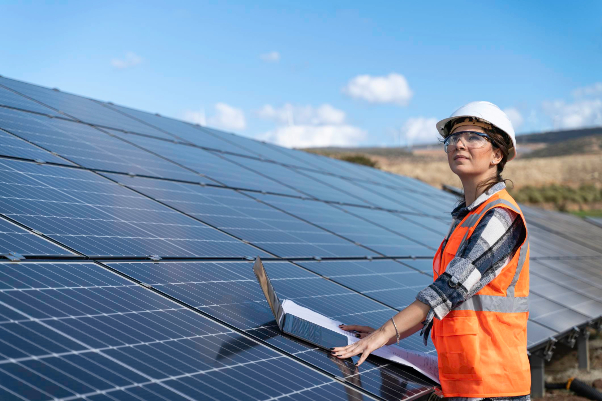 Worker installing clean energy solar panels