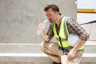 Male construction worker working in a very hot day.