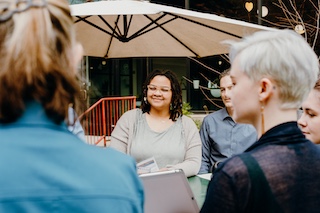 A group of people with the focus on a woman smiling.