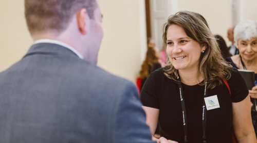 A woman shakes hans with a Congressional staffer on Capitol Hill