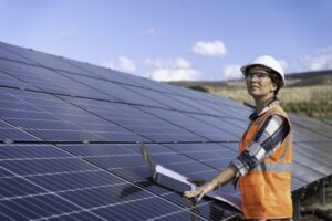 Inspection, tablet and engineer working with solar energy, sustainable electricity and vision for eco friendly power in nature. Power plant, renewable energy and woman with solar panels for future