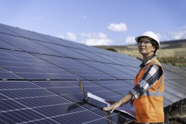 Inspection, tablet and engineer working with solar energy, sustainable electricity and vision for eco friendly power in nature. Power plant, renewable energy and woman with solar panels for future