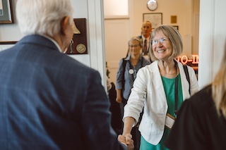 Woman shaking hands at a lobby meeting